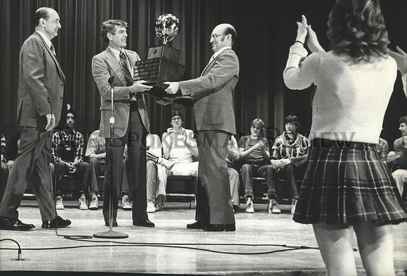 1981 Press Photo High School principals award a trophy to Coach Dave Robertson