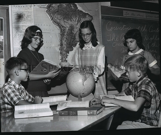 1965 Press Photo Students study books, maps and a globe, Comstock School