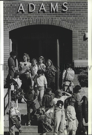 1989 Press Photo Adams Elementary students rush outside the campus