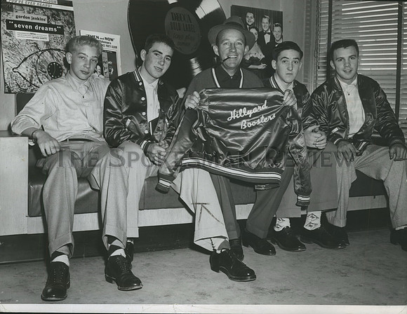 1955 Press Photo Bing Crosby holding a Hillyard Boosters jacket.