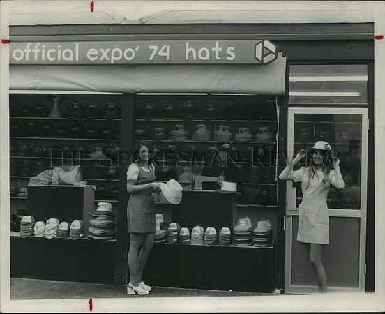 1974 Press Photo Young women trying on official Expo '74 hats.