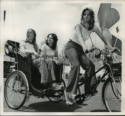 1974 Press Photo 3 girls pedal the bike conveyances taking visitors around Expo.