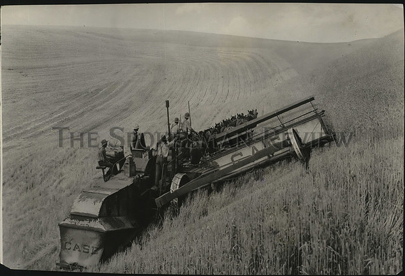 1937 Press Photo Walter Lloyd cutting wheat on steep  ground with modern combine
