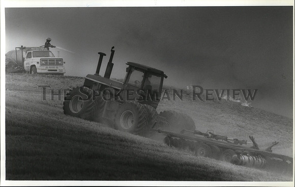 1992 Press Photo Firefighters spray water on a blaze at the John Daly Farm