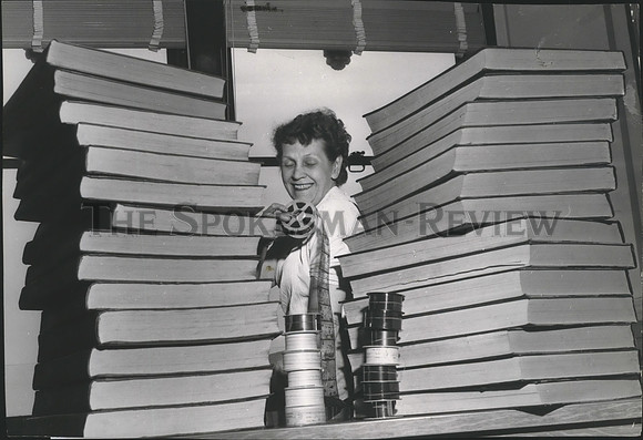 1957 Press Photo Mrs. Carroll Clark with rolls of film-Spokesman Review